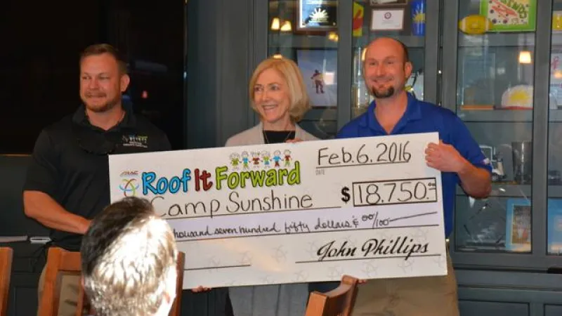 Casey Beaver and John Phillips with the executive Director of Camp Sunshine (Sally Hale).