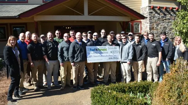 The GA team proudly presents a check for $18,750 to Camp Sunshine!