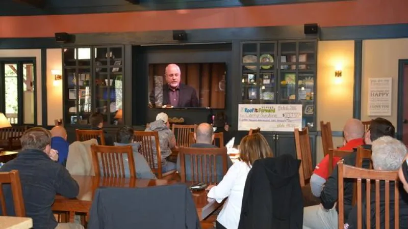 Picture of the team watching a Dave Ramsey video at our launch party.