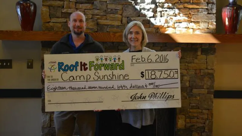 ARAC Roof It Forward presents a check for $18,750 to Camp Sunshine.
