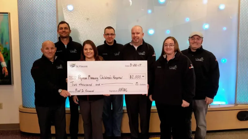 Roof It Forward presenting a check to the Peyton Manning Children's Hospital in 2017.