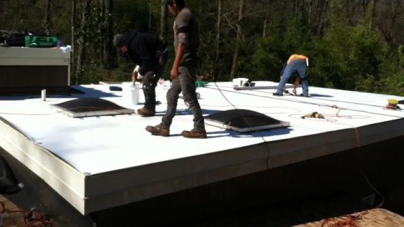 Crew replacing the TPO section of the roof