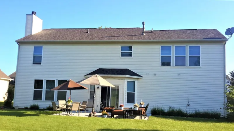 The Driftwood color of the Duration shingle is a perfect complement to this home's exterior.