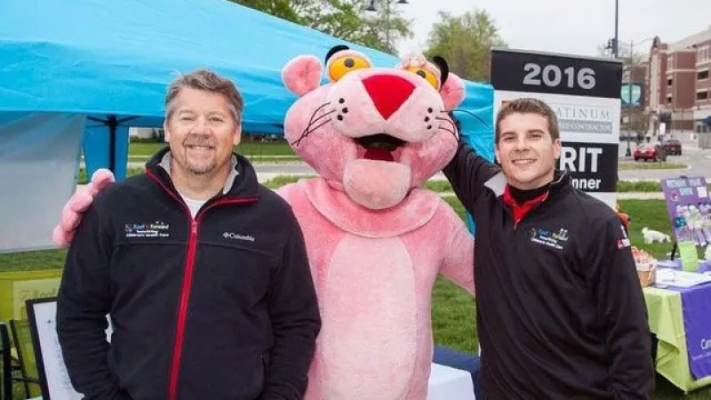 Some of our team members take a picture with the OC Pink Panther.
