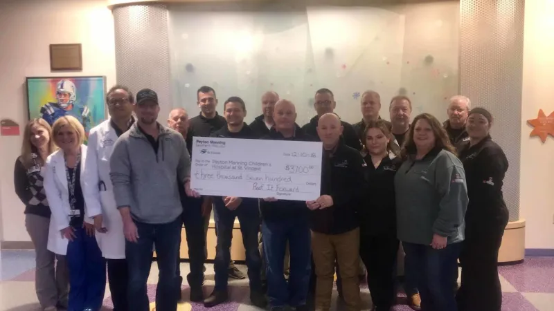 Roof It Forward presenting a check to the Peyton Manning Children's Hospital in 2018.