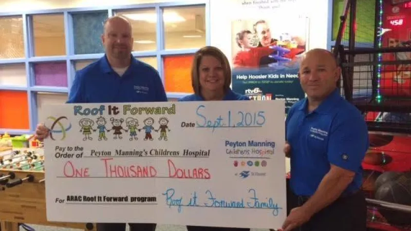 Roof It Forward presenting a check to the Peyton Manning Children's Hospital in 2015.