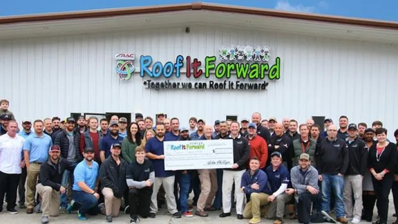 a group of people standing in front of a crowd posing for the camera