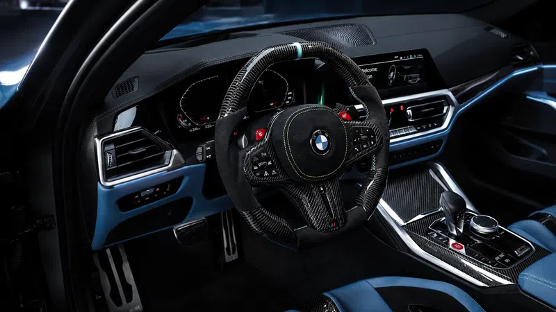BMW car interior with carbon fiber steering wheel, digital dashboard, blue leather seats, and modern center console.