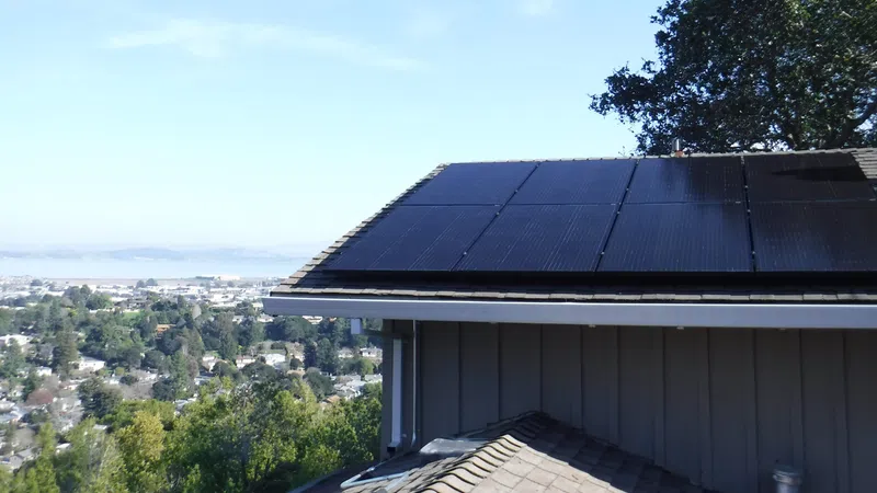 a roof of a building with trees and a city in the background