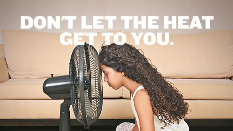 a girl in front of a fan