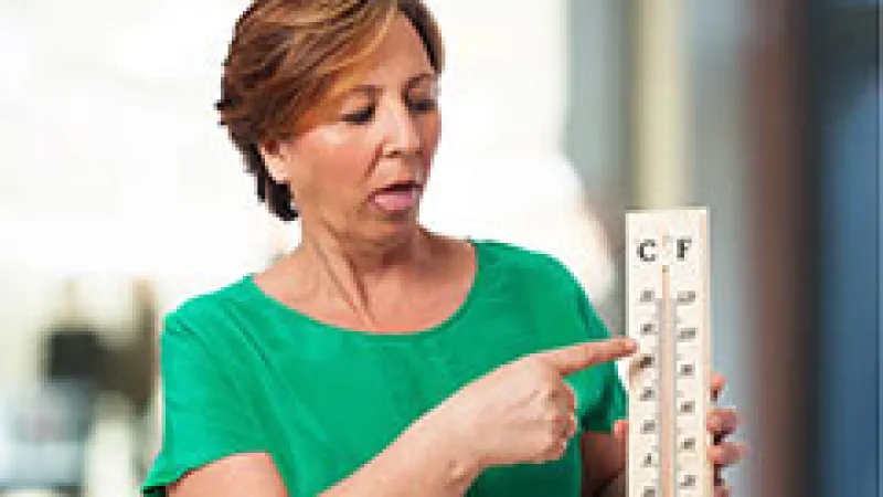 a woman holding a thermometer