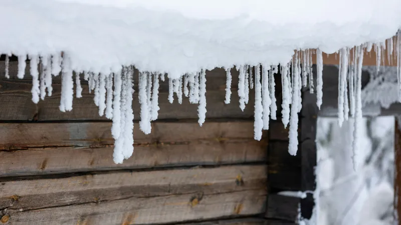 a wooden wall with snow on it