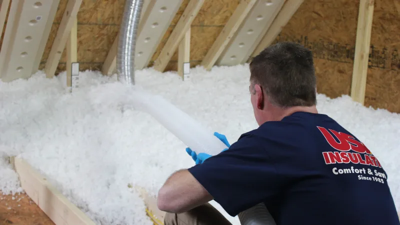 a man installing blown in insulation