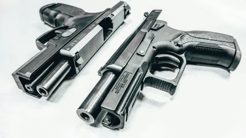a group of black and silver guns