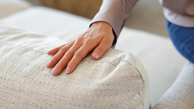 a person's hand on a white towel