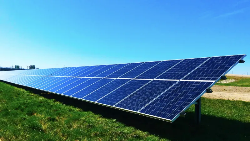 a solar panel on a grassy field