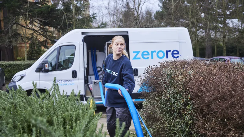 a person with a shovel in front of a van