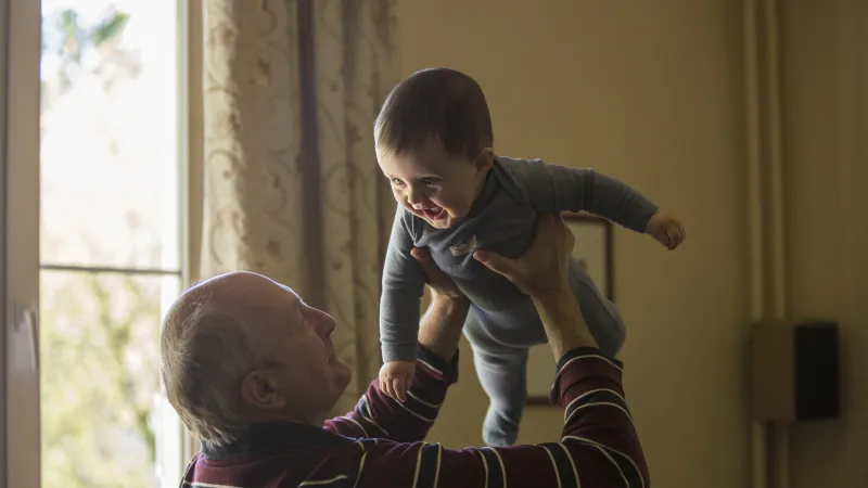 a boy holding a baby