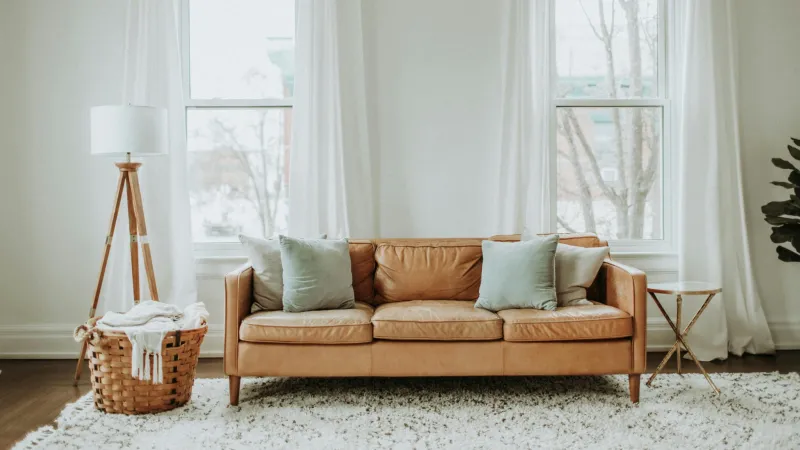 a leather couch in a clean white room