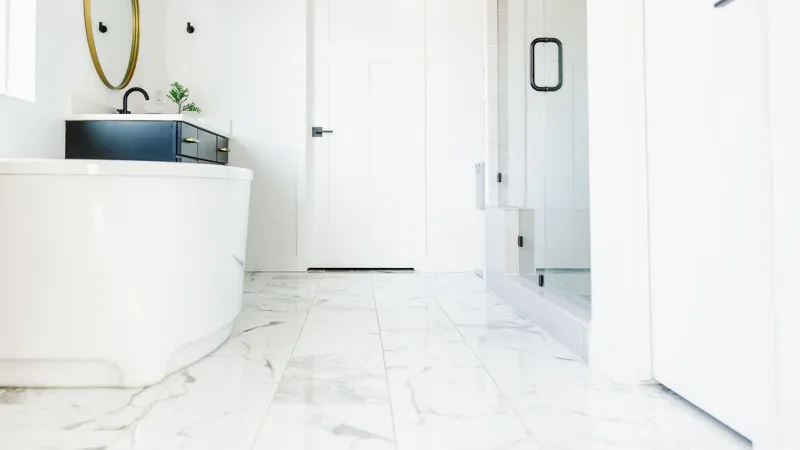 a white bathroom with white slippery tiles