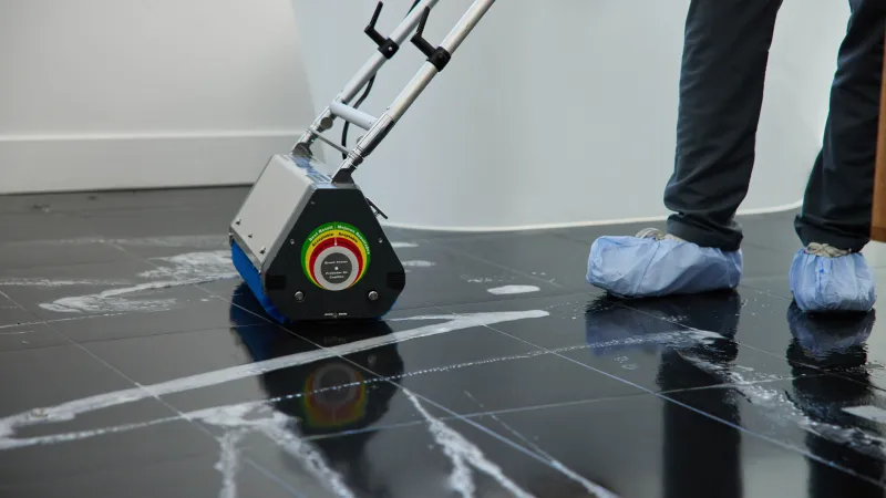 Professional Zerorez technician cleaning grout and tile floor in bathroom