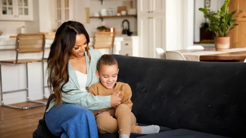 a person and a child sitting on a couch