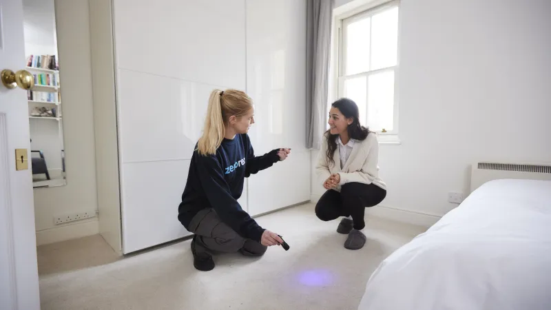 a couple of women sitting on a bed