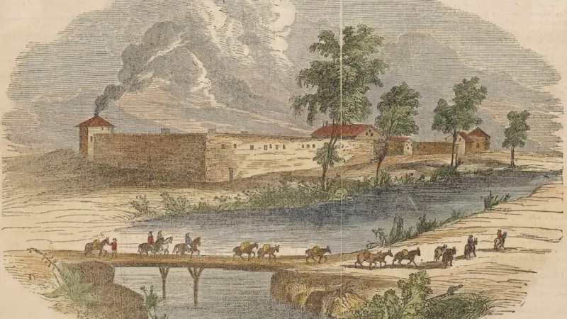 a river with a few buildings and a few horses