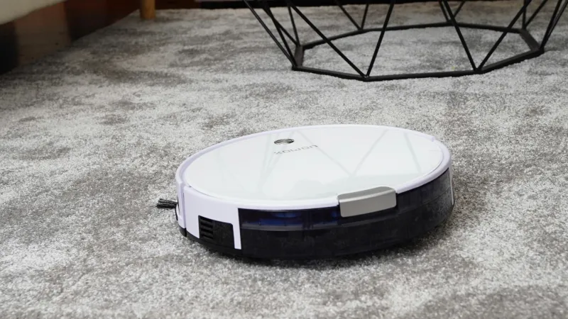 a robot vacuum cleaning a carpeted living room floor making noise and sounds