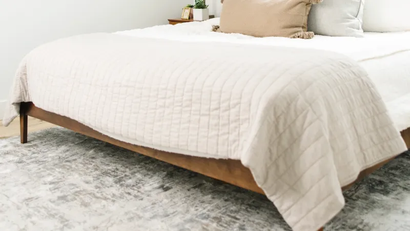 a bed with a white bed spread