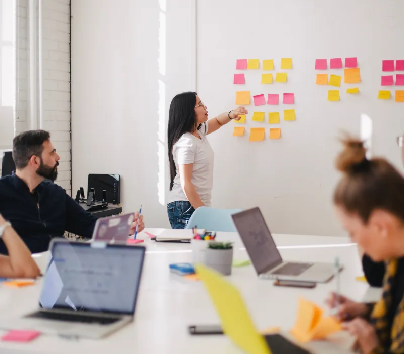 a group of people listening to someone at a meeting