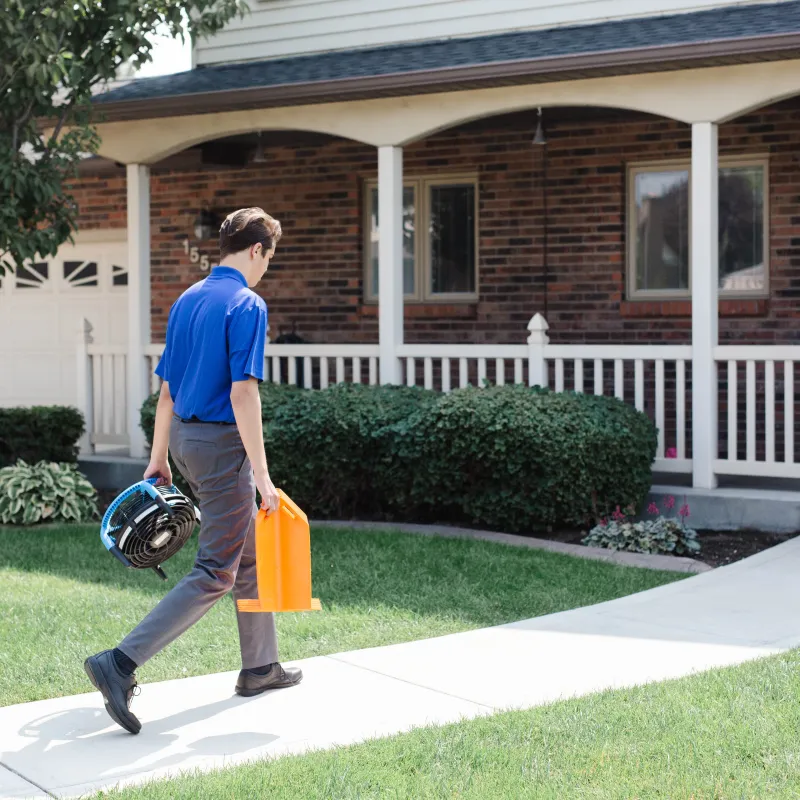 a man carrying a bucket