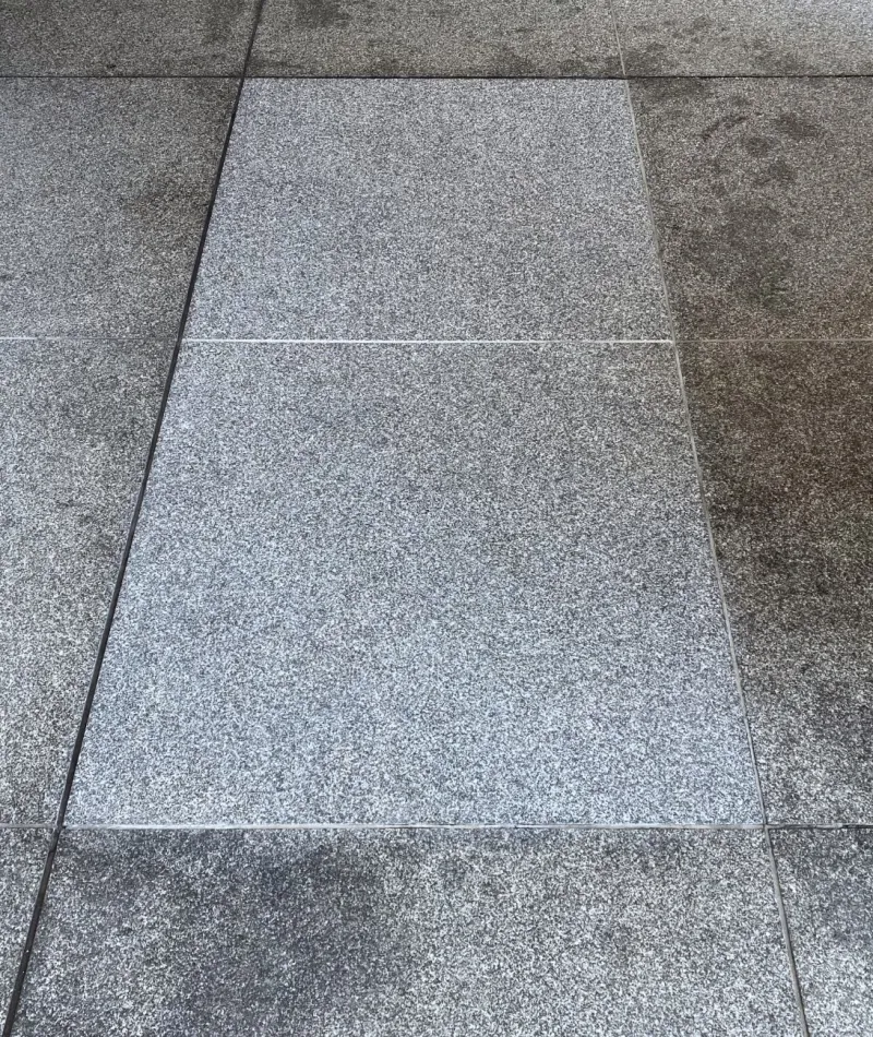 Side-by-side comparison of tiled floor before and after deep cleaning showing removal of stains and dirt buildup.