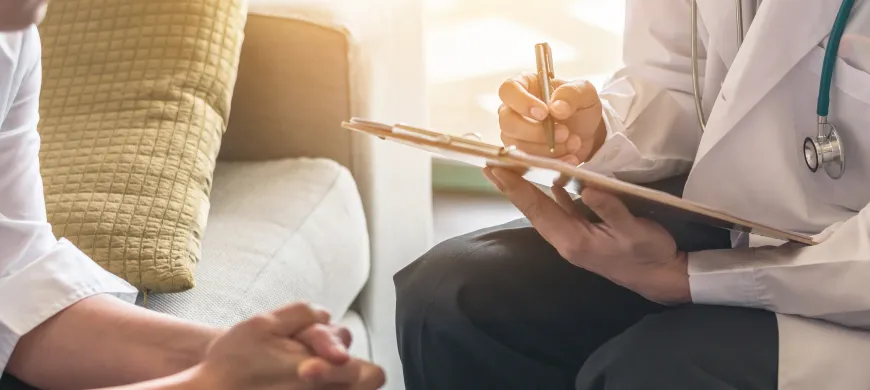 a doctor holding a patient's hand.