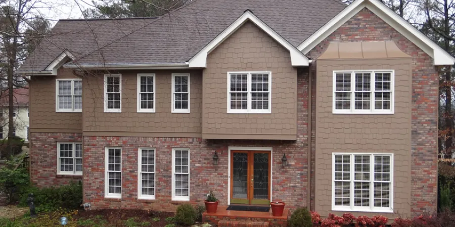 a brick building with a lawn in front of it