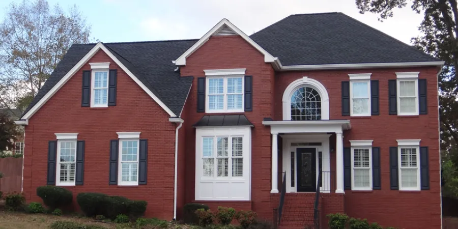 a red house with a driveway