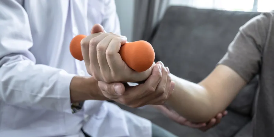 a person holding an orange weight