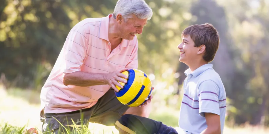 a man and a boy playing with a ball