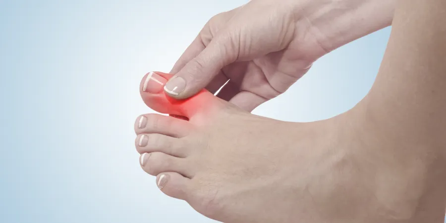 a close-up of hands holding a toe