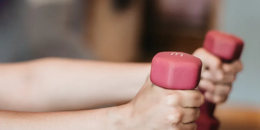 a person's hand holding a pink object