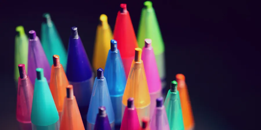 a pencil next to a bottle of items