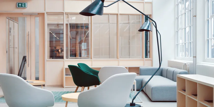 a green office chair next to a window