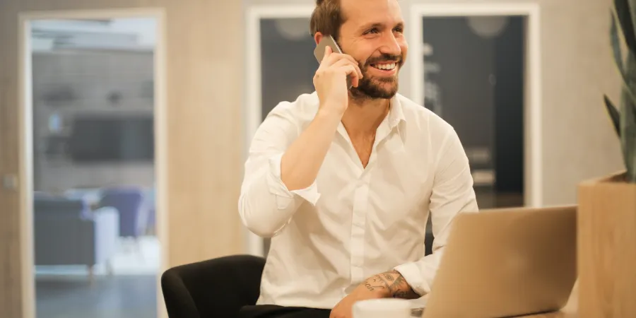 a person sitting in a chair talking on the phone