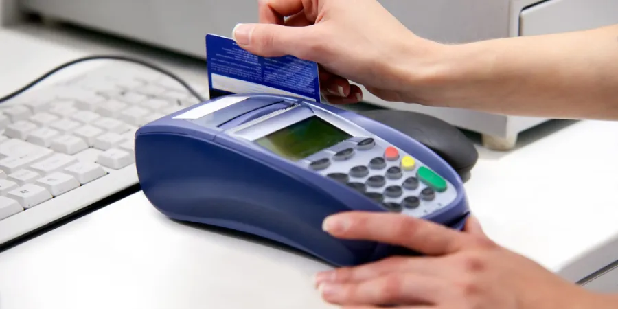 a person swiping a credit card