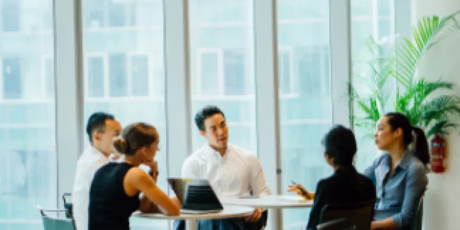 a group of people sitting around a table