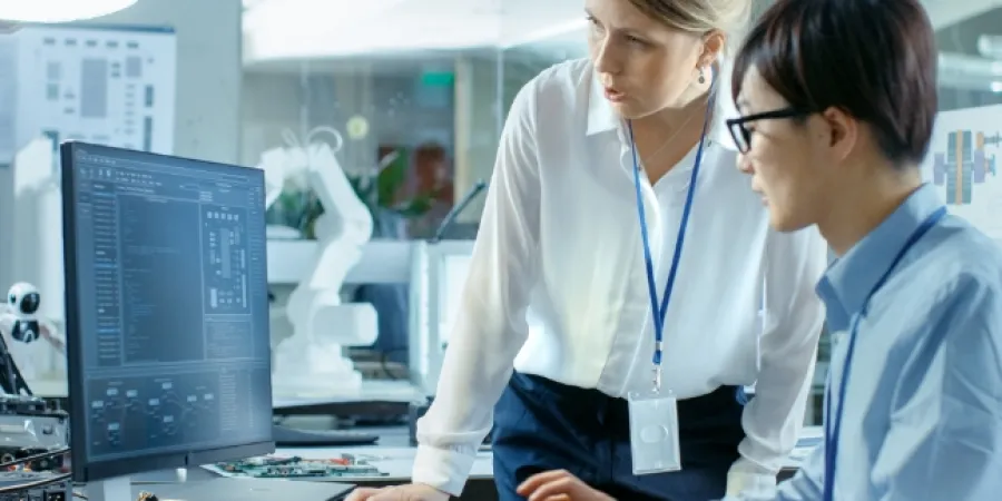 two employees looking at a computer screen