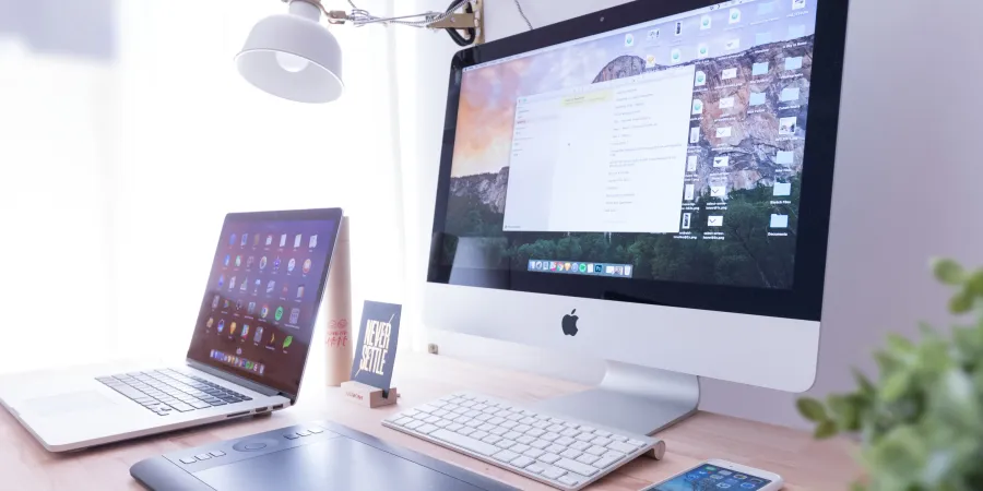 a desk with a laptop and a phone