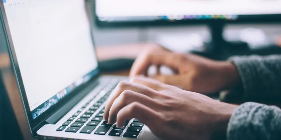 a person typing on a laptop