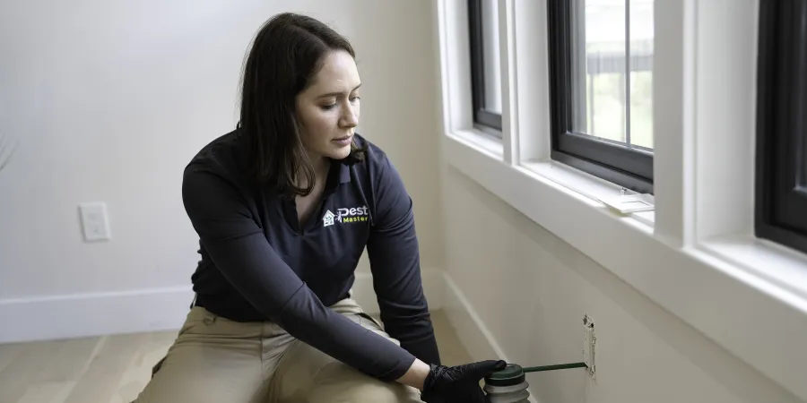 a woman sitting spraying into an outlet