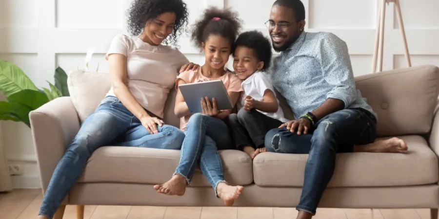 a family sitting on a couch